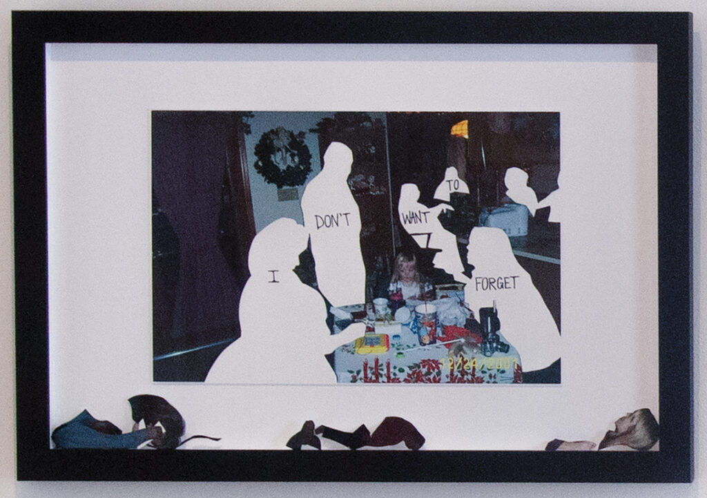 Framed print scraps of a family sitting around a table, but the people are missing.