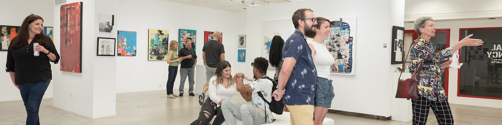 photo of the mood room gallery space with guests looking at artwork.